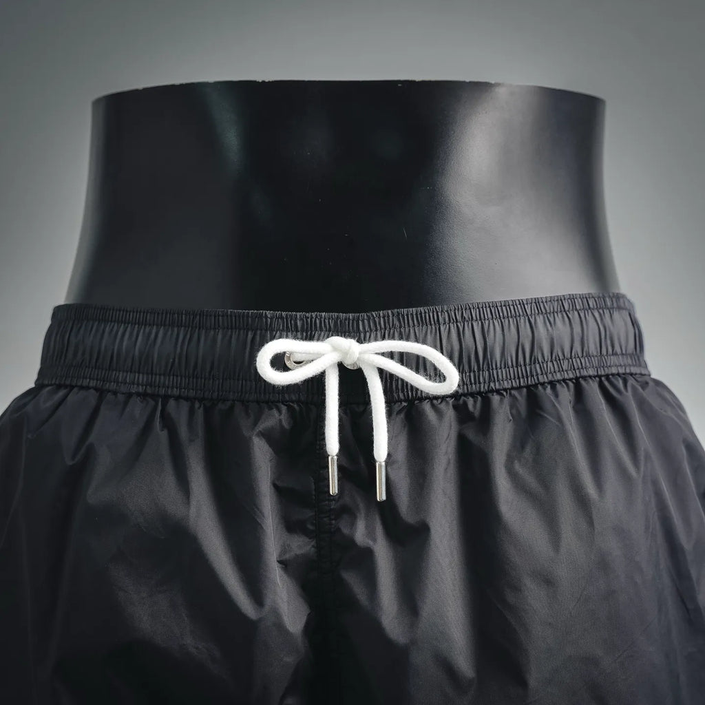 Moncler black swim shorts with elastic waist and white braided drawcords