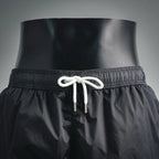 Moncler black swim shorts with elastic waist and white braided drawcords