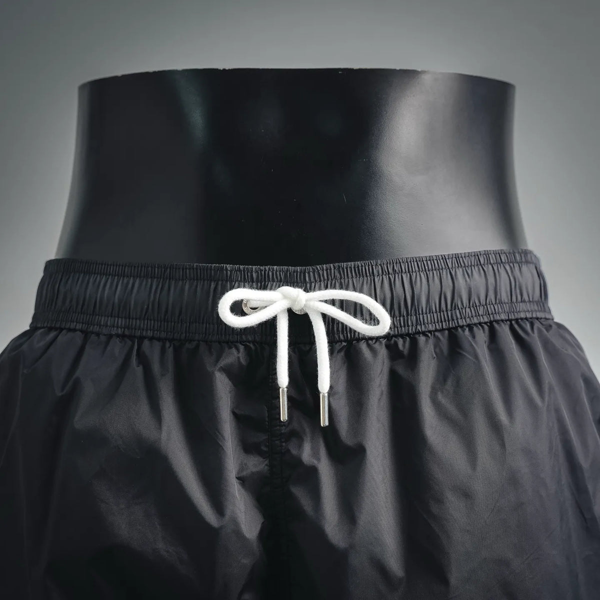 Moncler black swim shorts with elastic waist and white braided drawcords