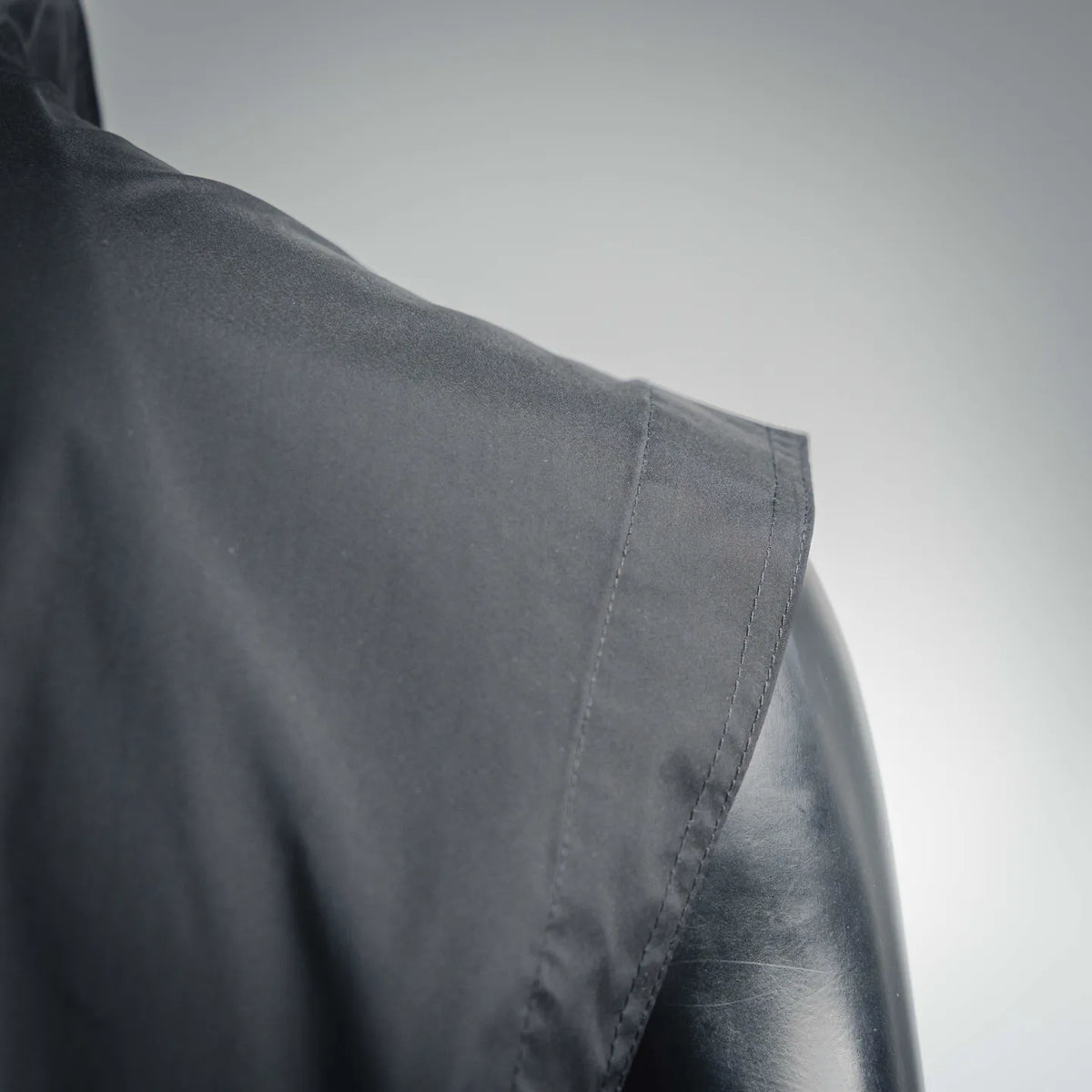 Dark Moncler gilet with side seam stitching and overlapping panel detail