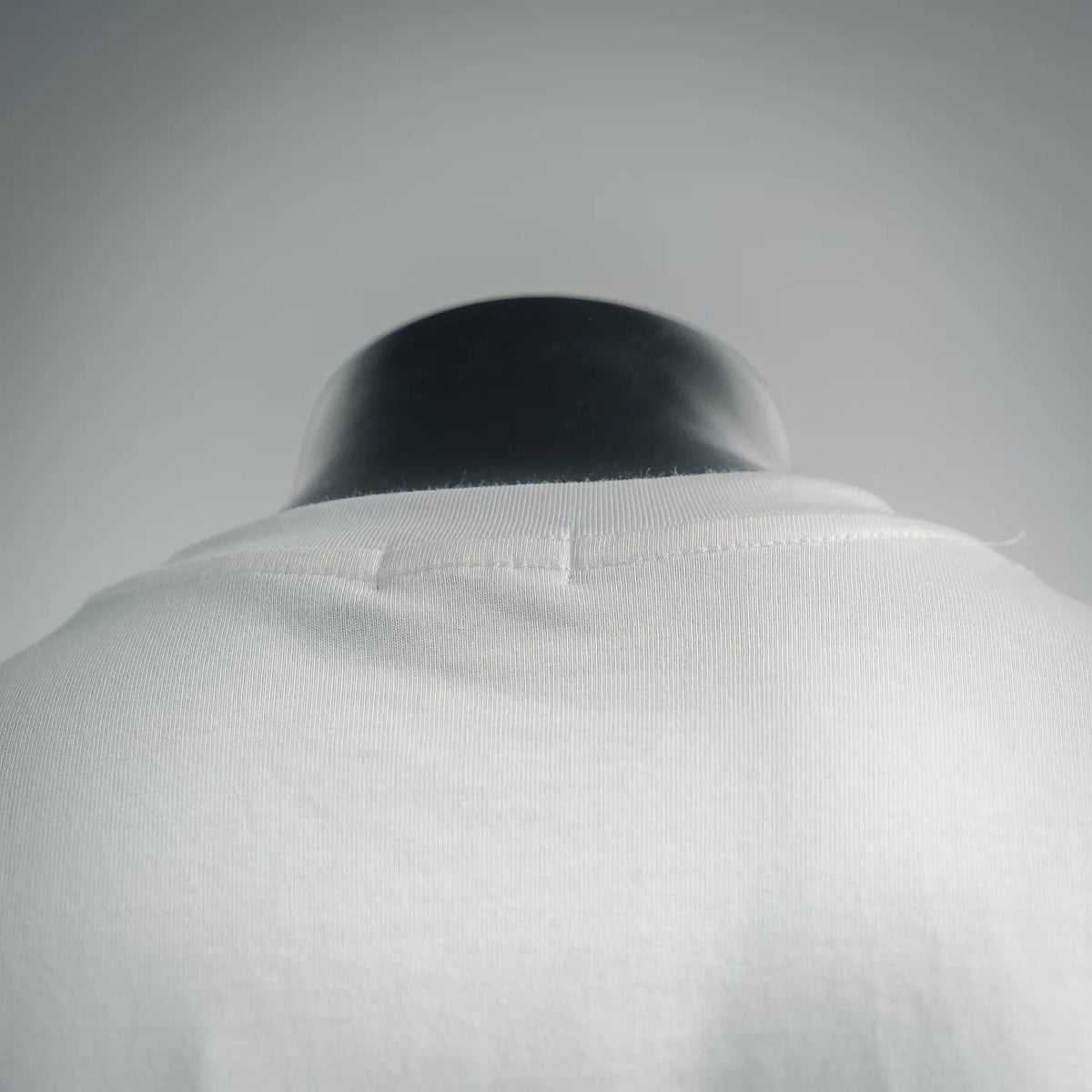 White crew-neck T-shirt collar detail with smooth seam