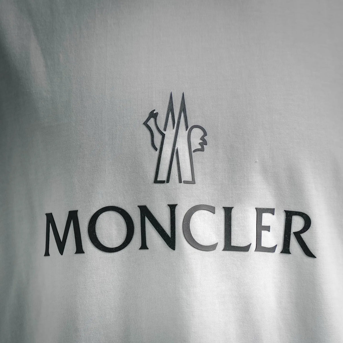 White T-shirt chest graphic with MONCLER lettering and emblem