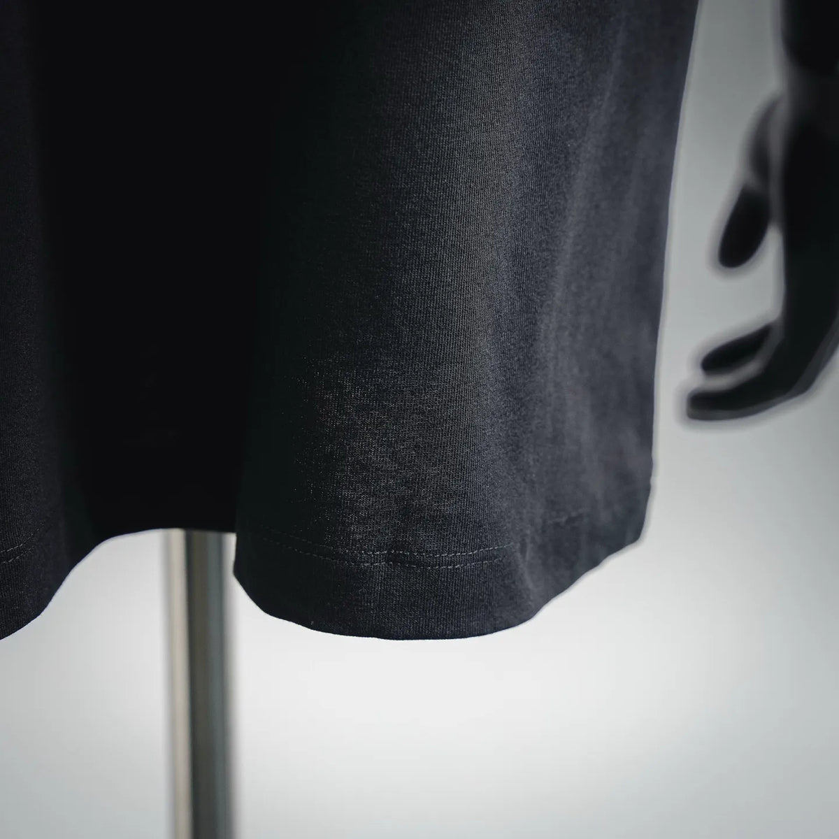 Black Moncler T-shirt hem detail with straight bottom stitching