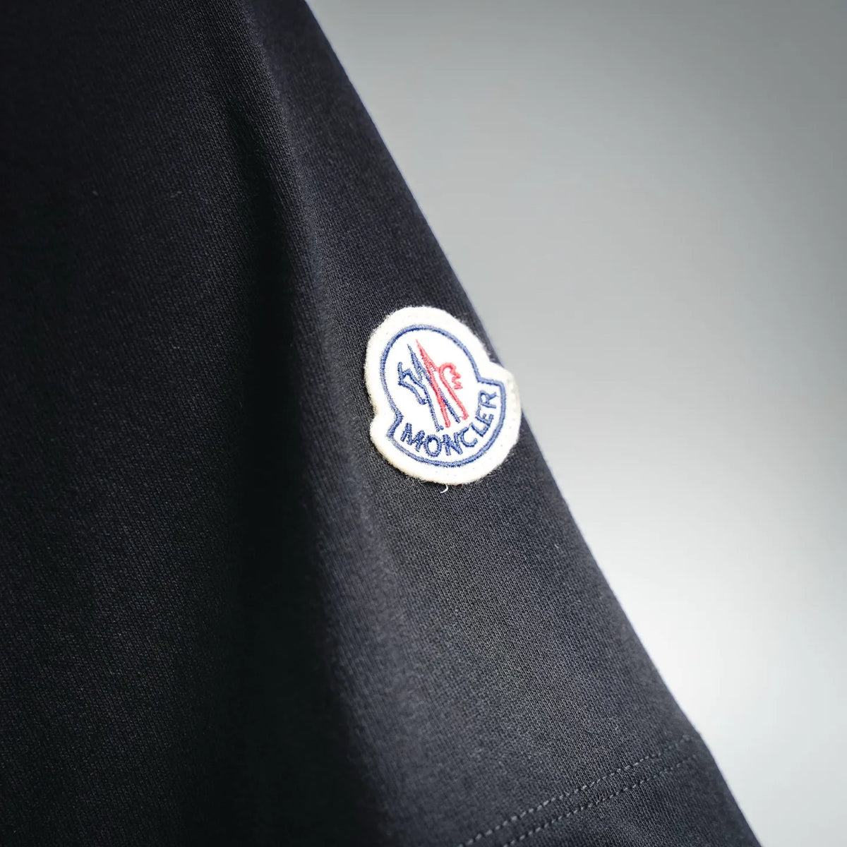 Black Moncler T-shirt sleeve with circular logo patch