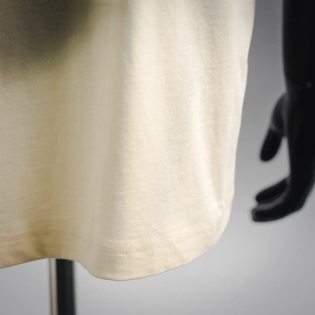 Moncler short-sleeve T-shirt side view in light cream with visible stitching
