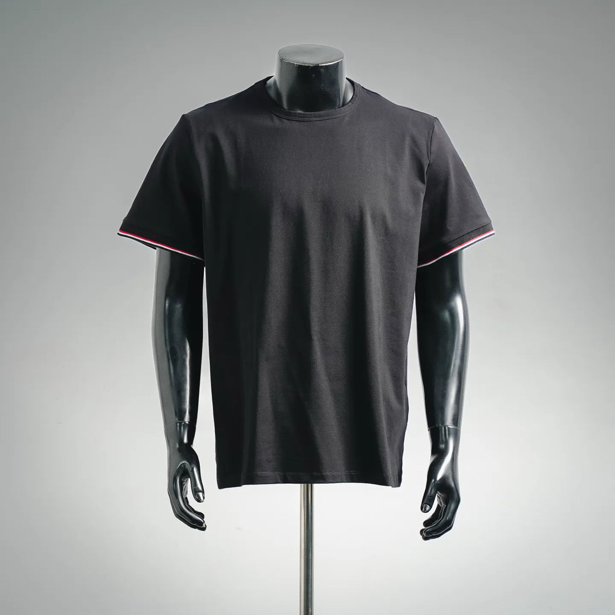 Black short-sleeve crewneck T-shirt with red and white striped trim at sleeves