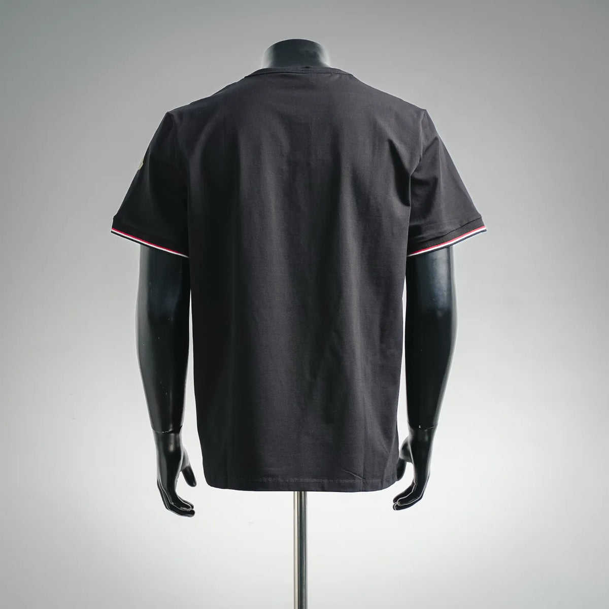 Black short-sleeve crewneck T-shirt, back view, striped trim at sleeves