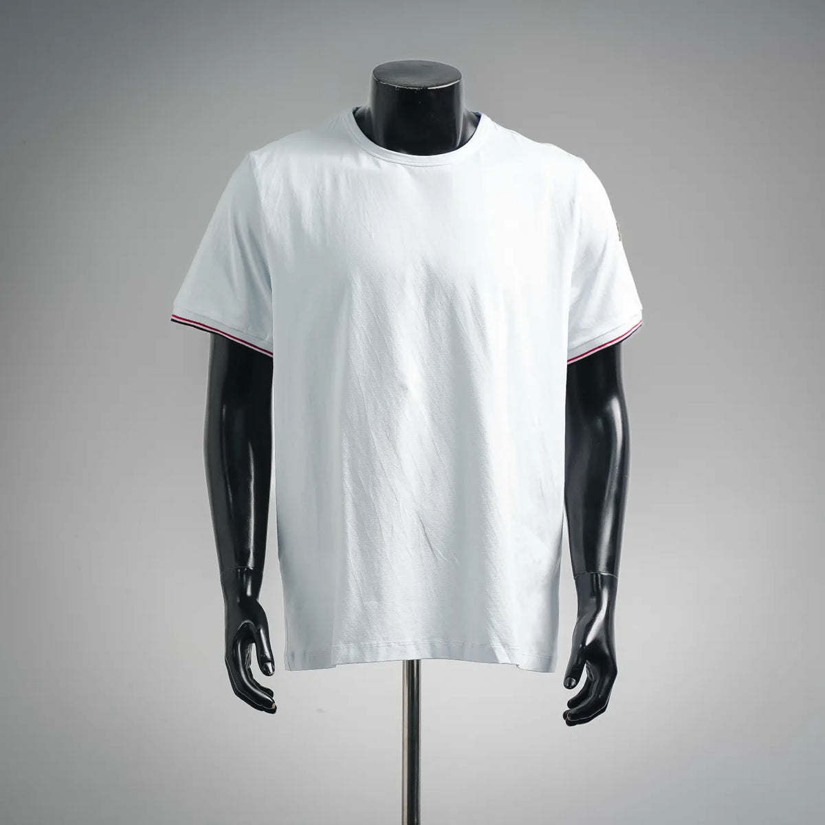 Moncler white short-sleeve T-shirt on mannequin, crew neck with red and navy striped cuff