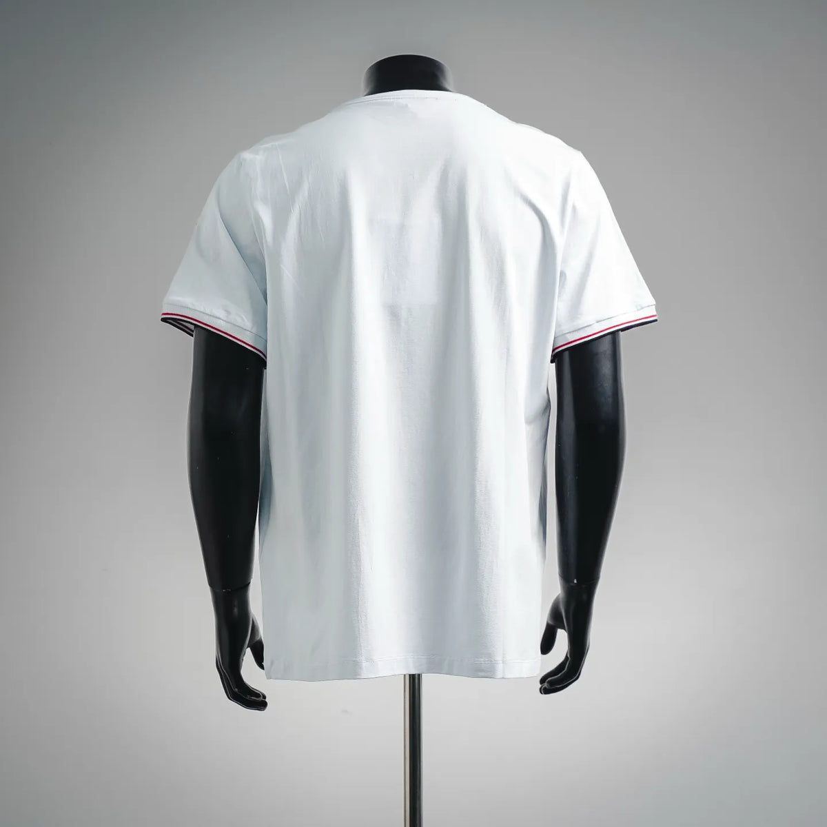 Moncler white short-sleeve T-shirt on mannequin, back view with red and navy striped sleeve hem