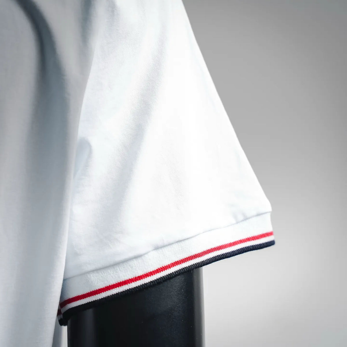 Moncler white T-shirt sleeve hem with red and navy striped rib trim