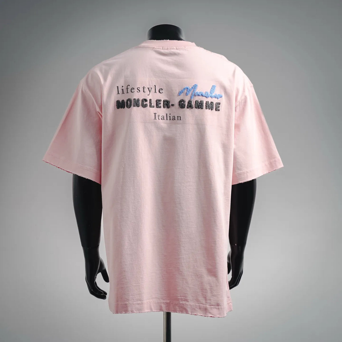 Pink backless crew-neck T-shirt with “lifestyle MONCLER” and “Italian” prints