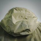 Olive green jacket hood with interior lining, close-up