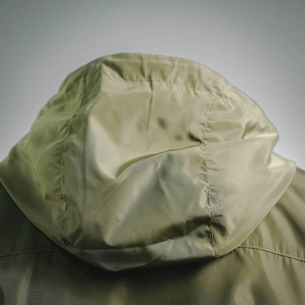 Olive green jacket hood with interior lining, close-up