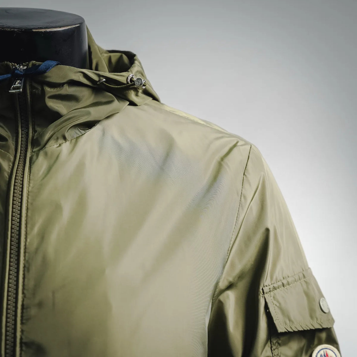Olive green Moncler jacket collar and front zipper area with snap placket detail