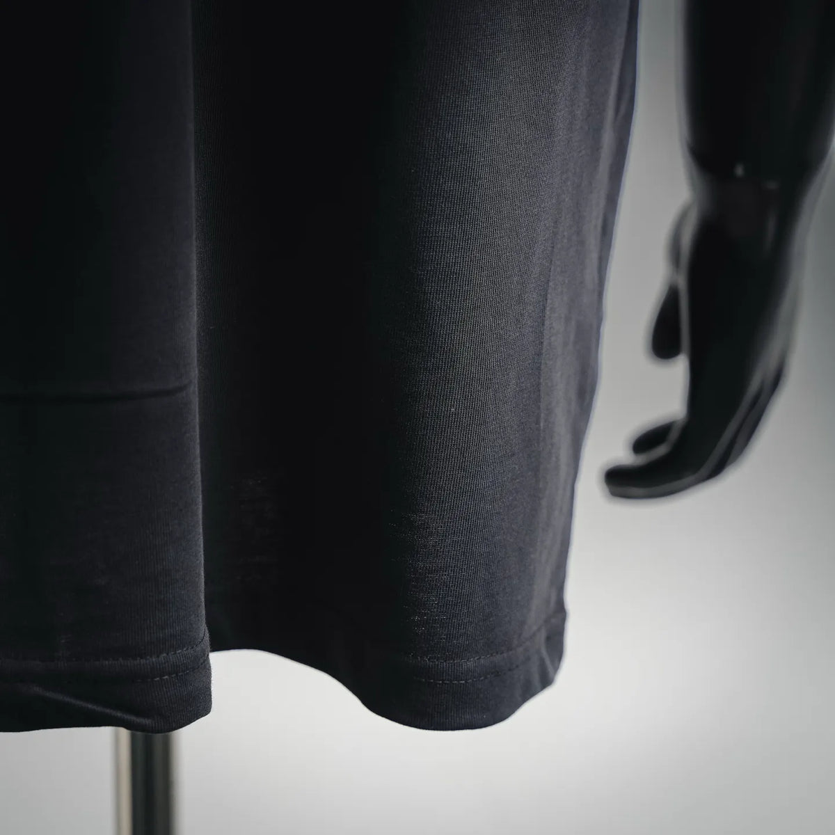 Black T-shirt hem with double-stitched finish