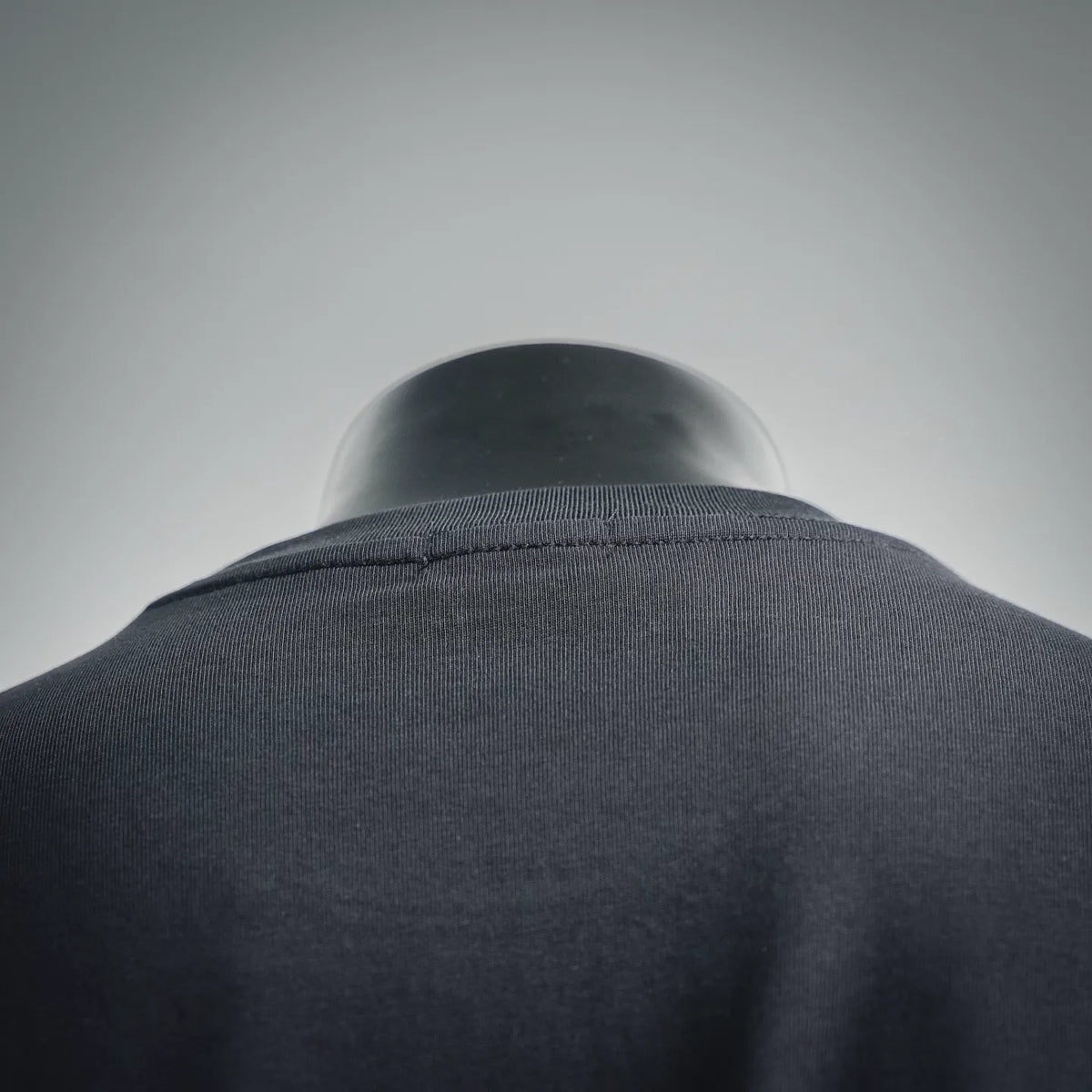 Black T-shirt collar and upper back seam detail