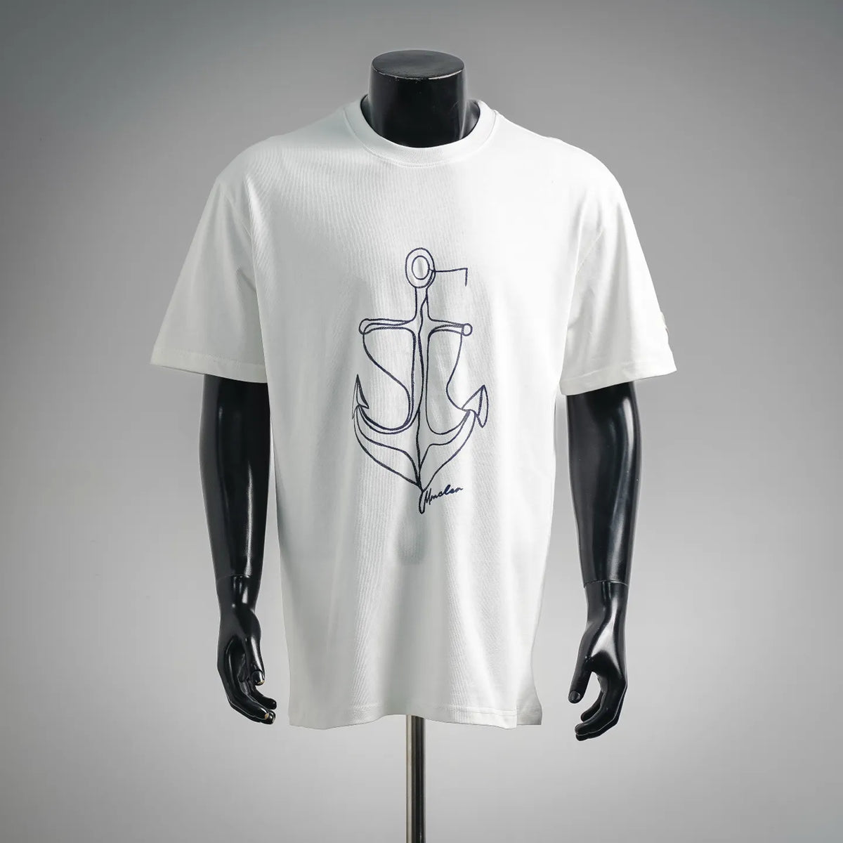 White crewneck T-shirt with blue anchor graphic on the front