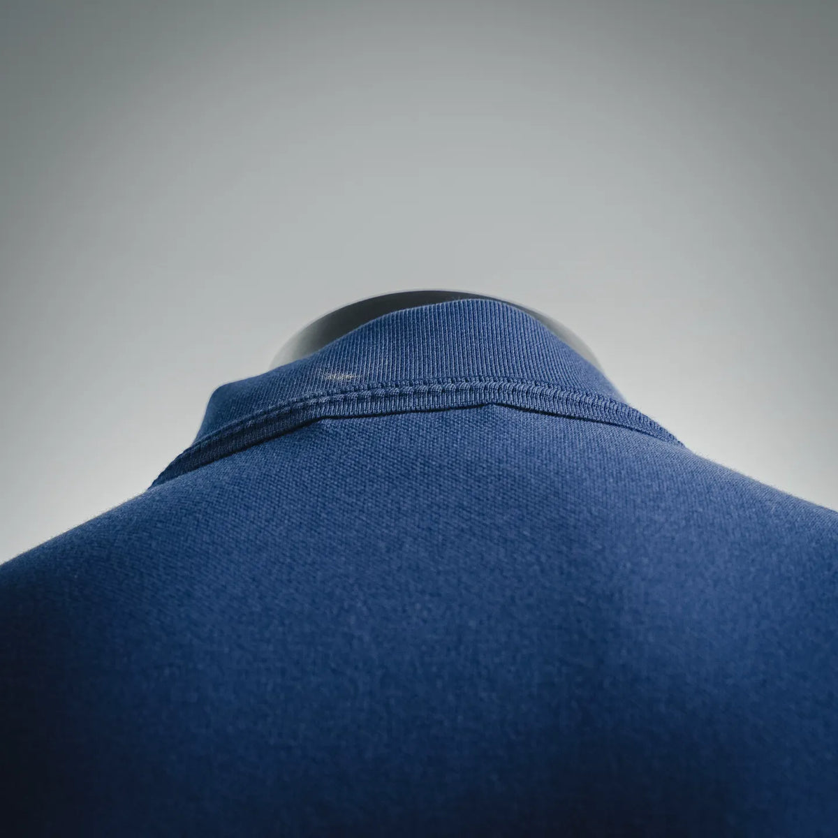 Dark blue polo shirt collar with neat folded seam detail