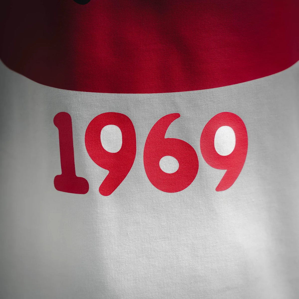 White T-shirt close-up of red “1969” graphic print