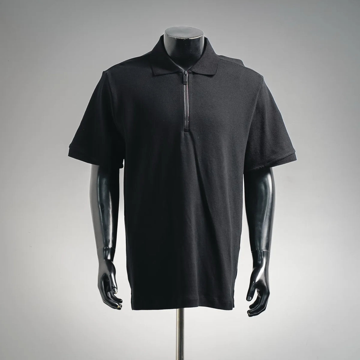 Black short-sleeve polo shirt with half-zip placket and collar