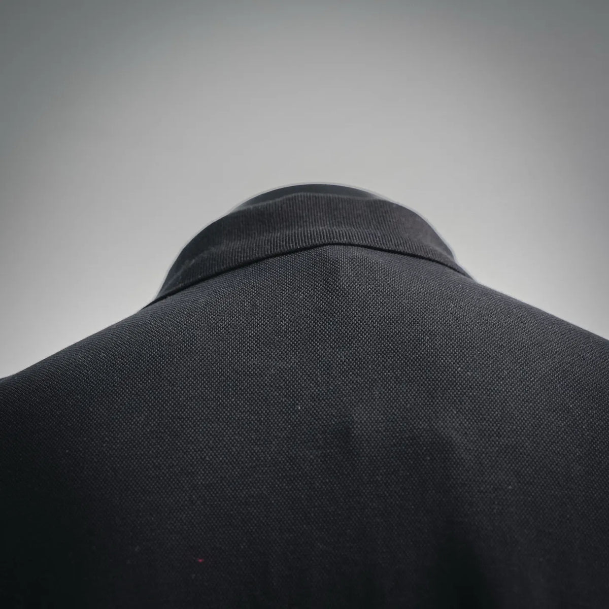 Black polo shirt back collar close-up