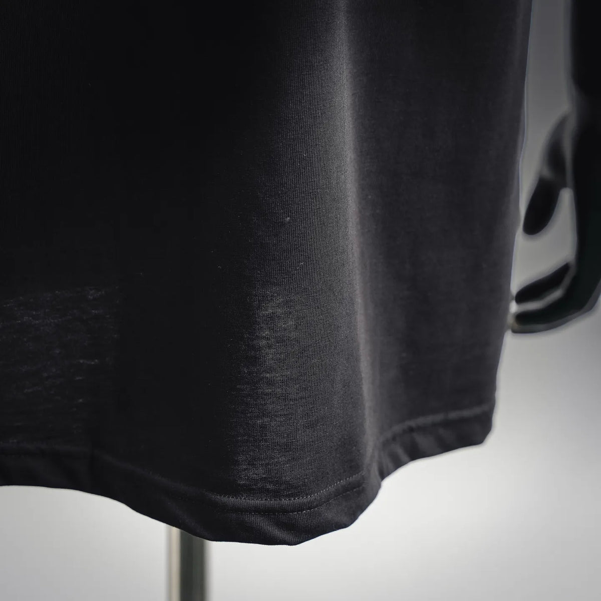 Moncler black T-shirt lower side seam and hem edge detail