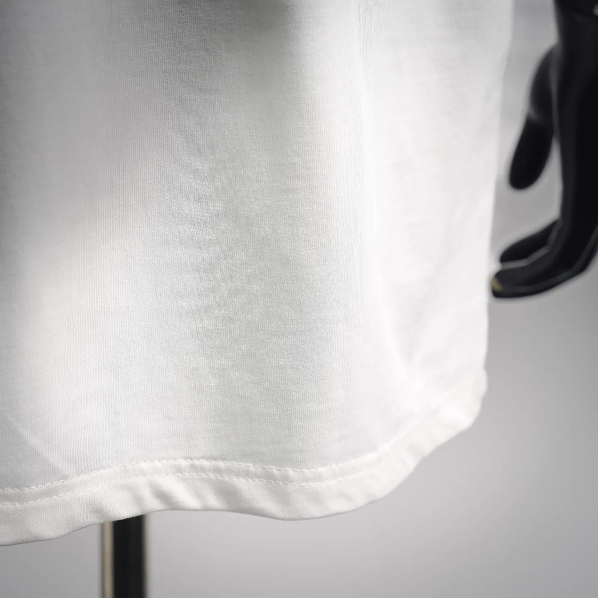 White T-shirt hem with stitched seam