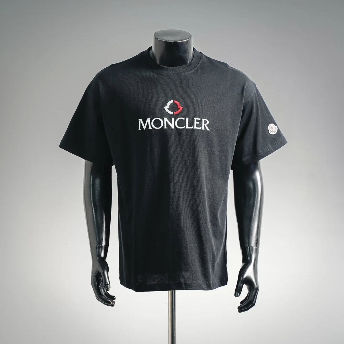 Moncler short-sleeve T-shirt on mannequin, dark crewneck, front MONCLER logo print