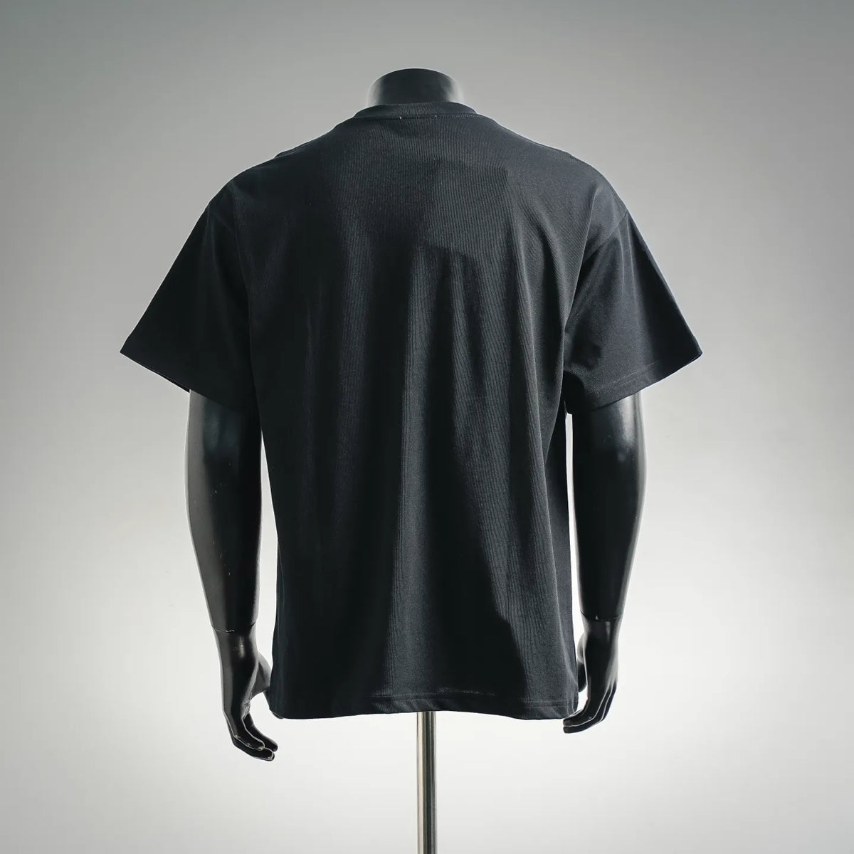 Moncler short-sleeve T-shirt on mannequin, dark crewneck, back view with no visible print