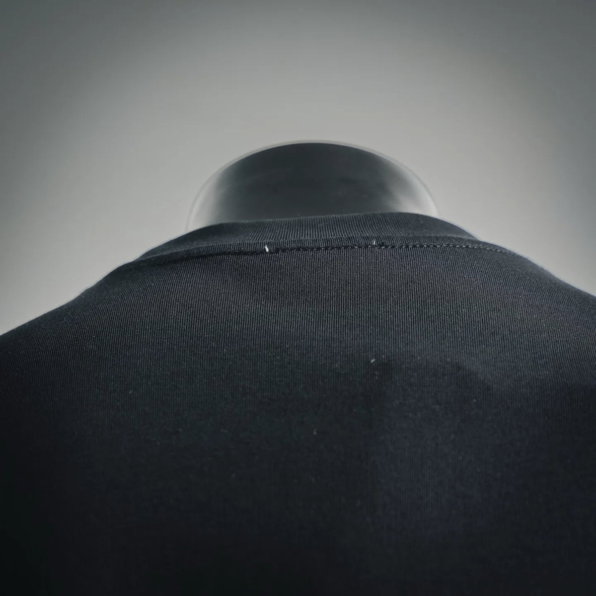 Moncler dark crewneck T-shirt collar close-up on mannequin, stitched neckline detail
