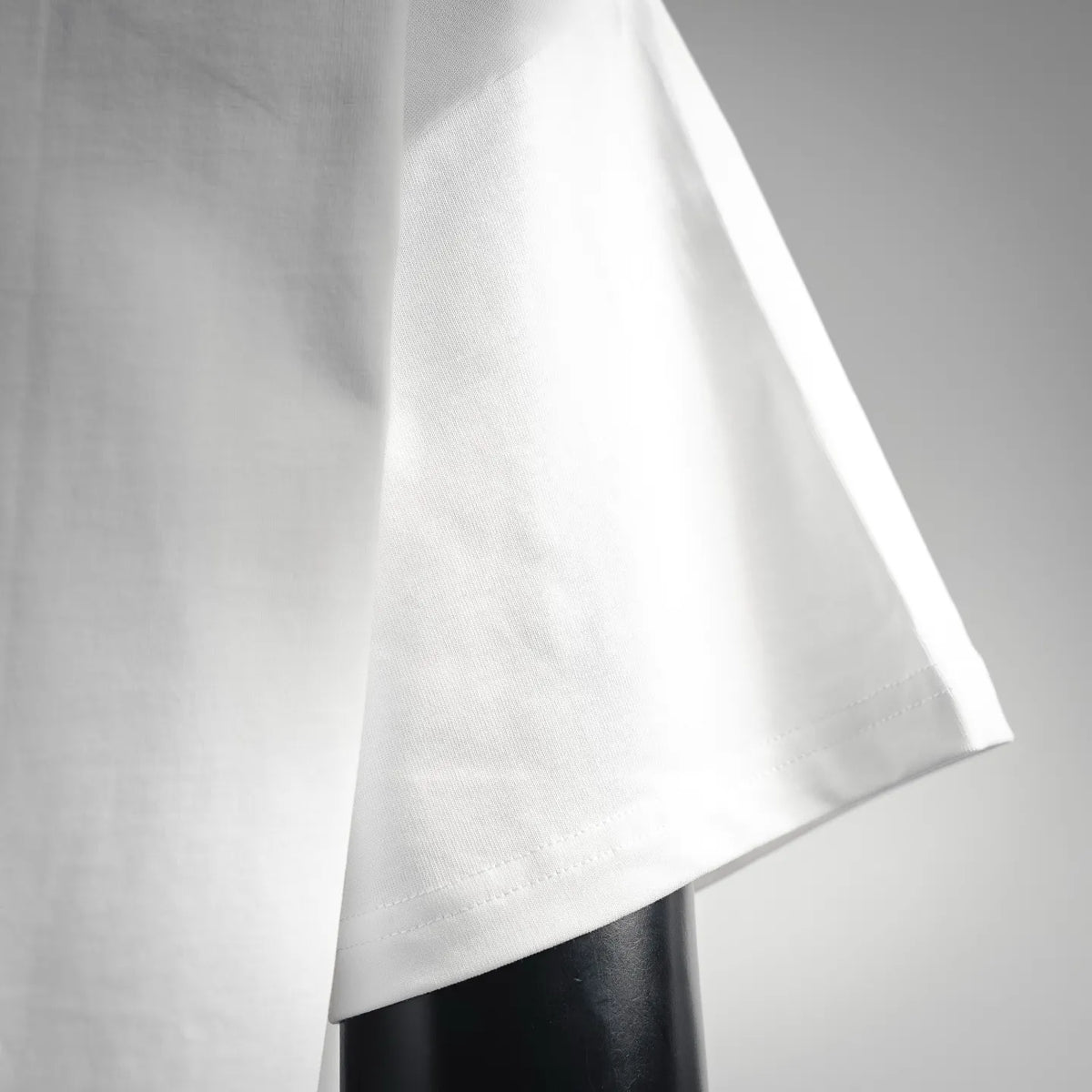 White short-sleeve T-shirt sleeve and side seam close-up