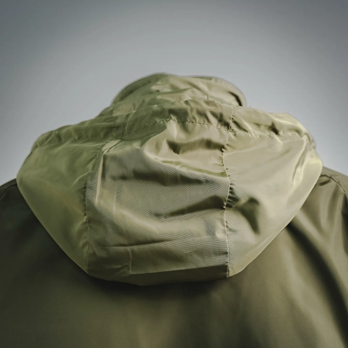 Olive hooded coat back with draped hood and seam stitching detail