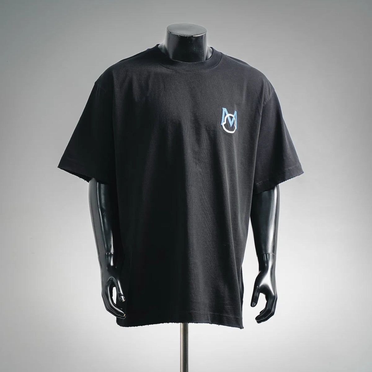 Black crewneck short-sleeve T-shirt with small blue-and-white Moncler M logo