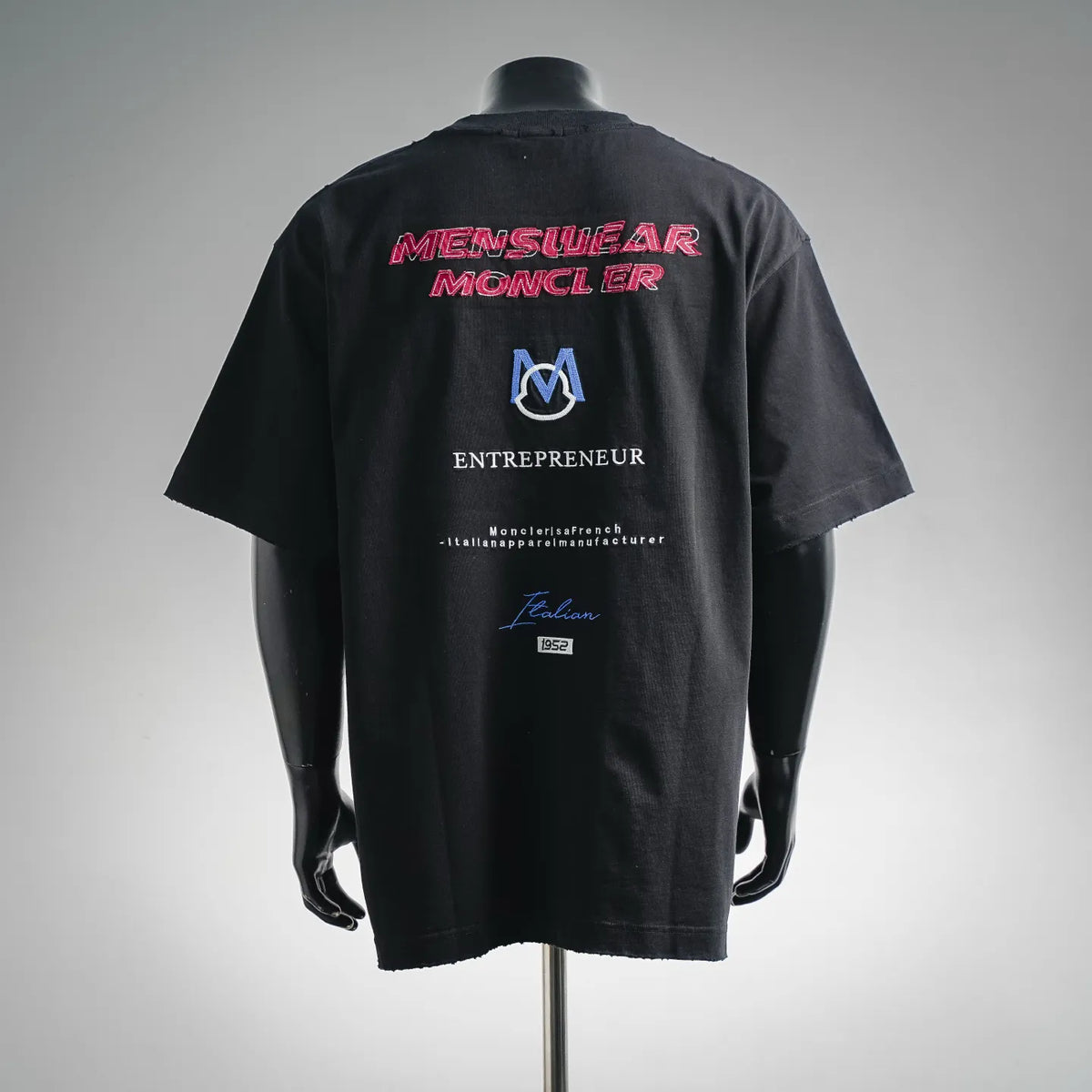 Black crewneck T-shirt with large back graphic text and blue Moncler M logo