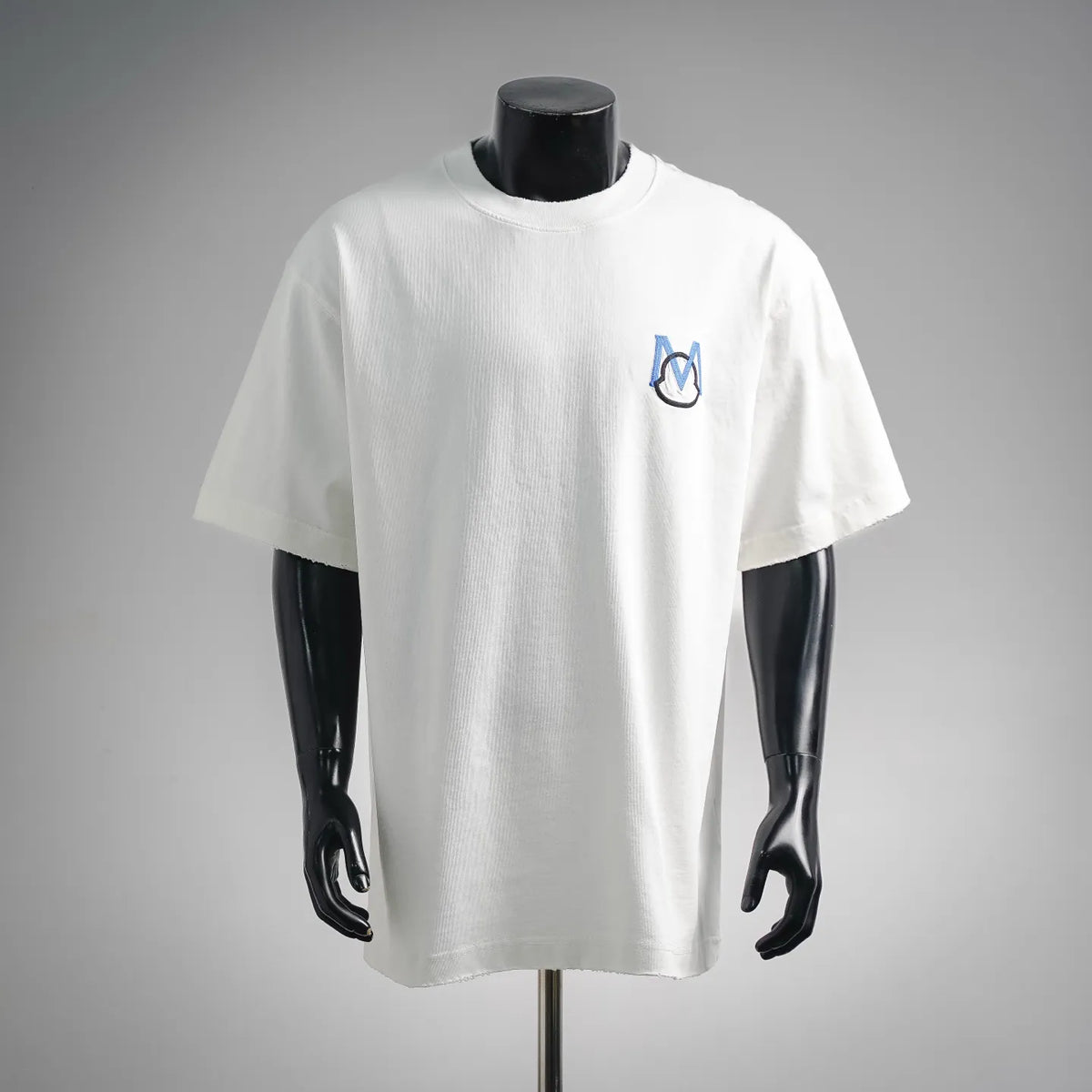 White short-sleeve T-shirt with blue and black logo on chest