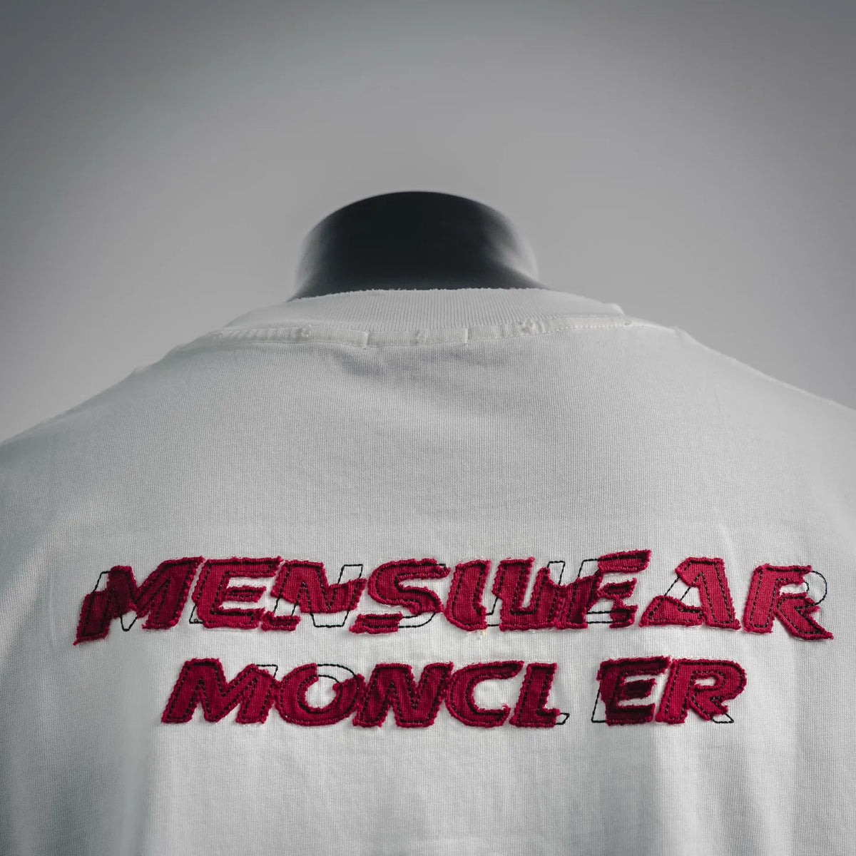 White T-shirt back detail with 'MESSUGAR MONCLER' red embroidered text