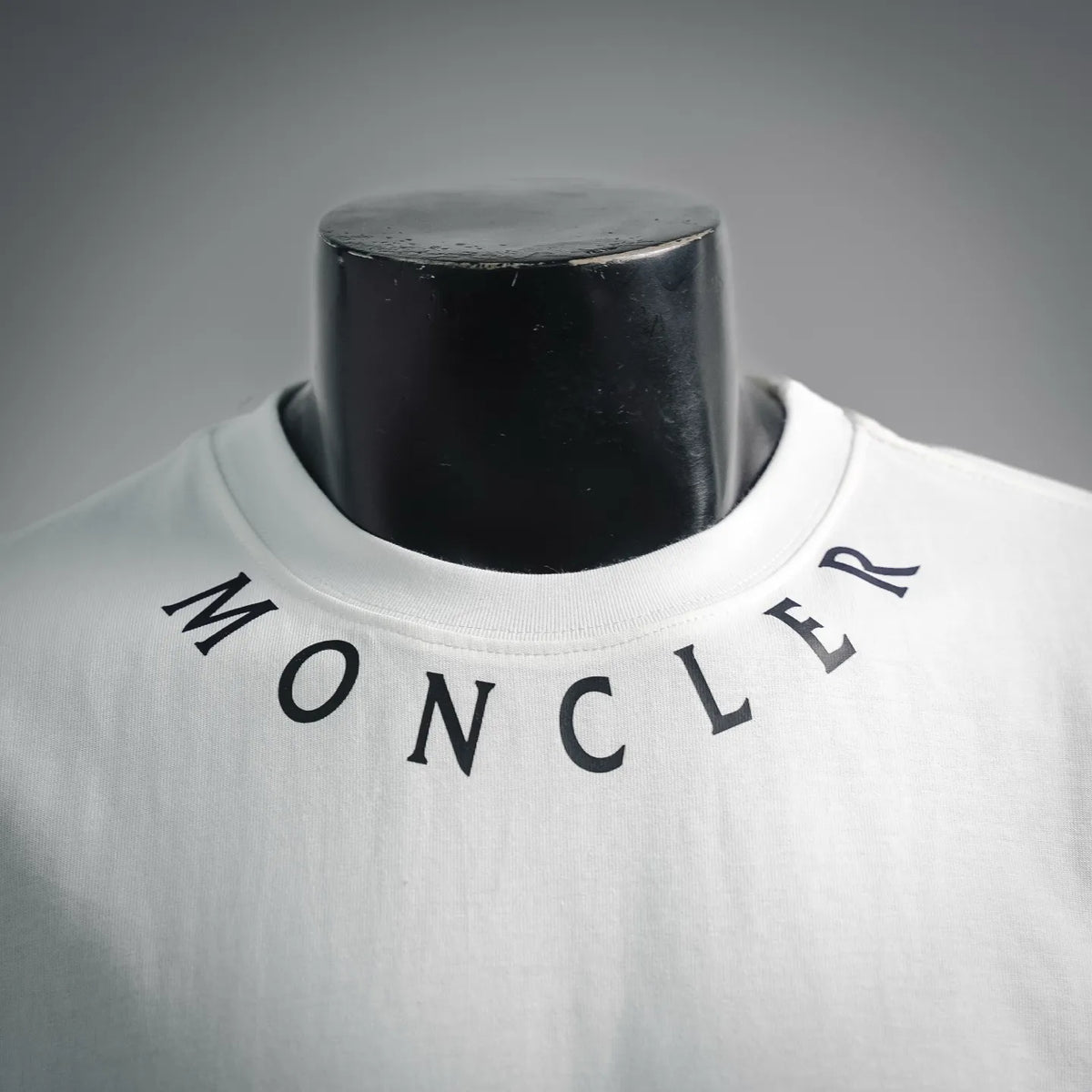 White crew-neck T-shirt with Moncler logo lettering and blue detail