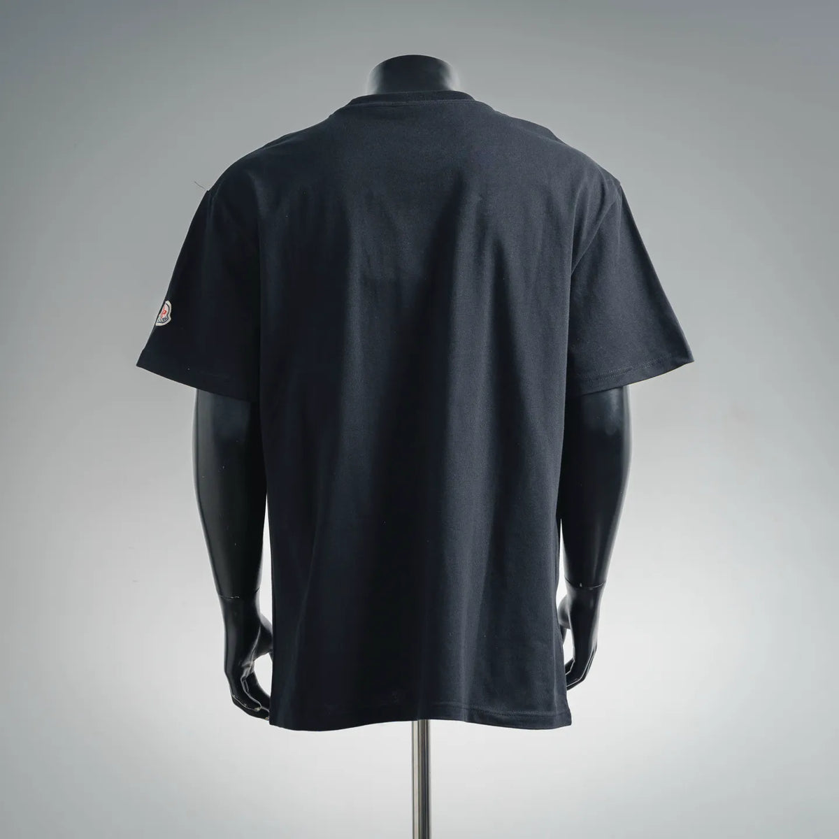 Dark short-sleeve T-shirt with logo on left sleeve and crew neck