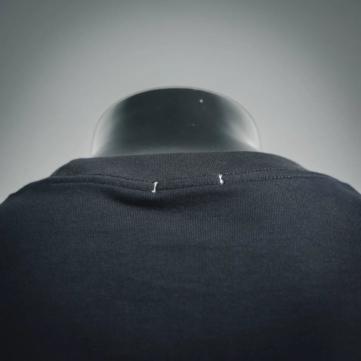 Black T-shirt neckline rib seam close-up