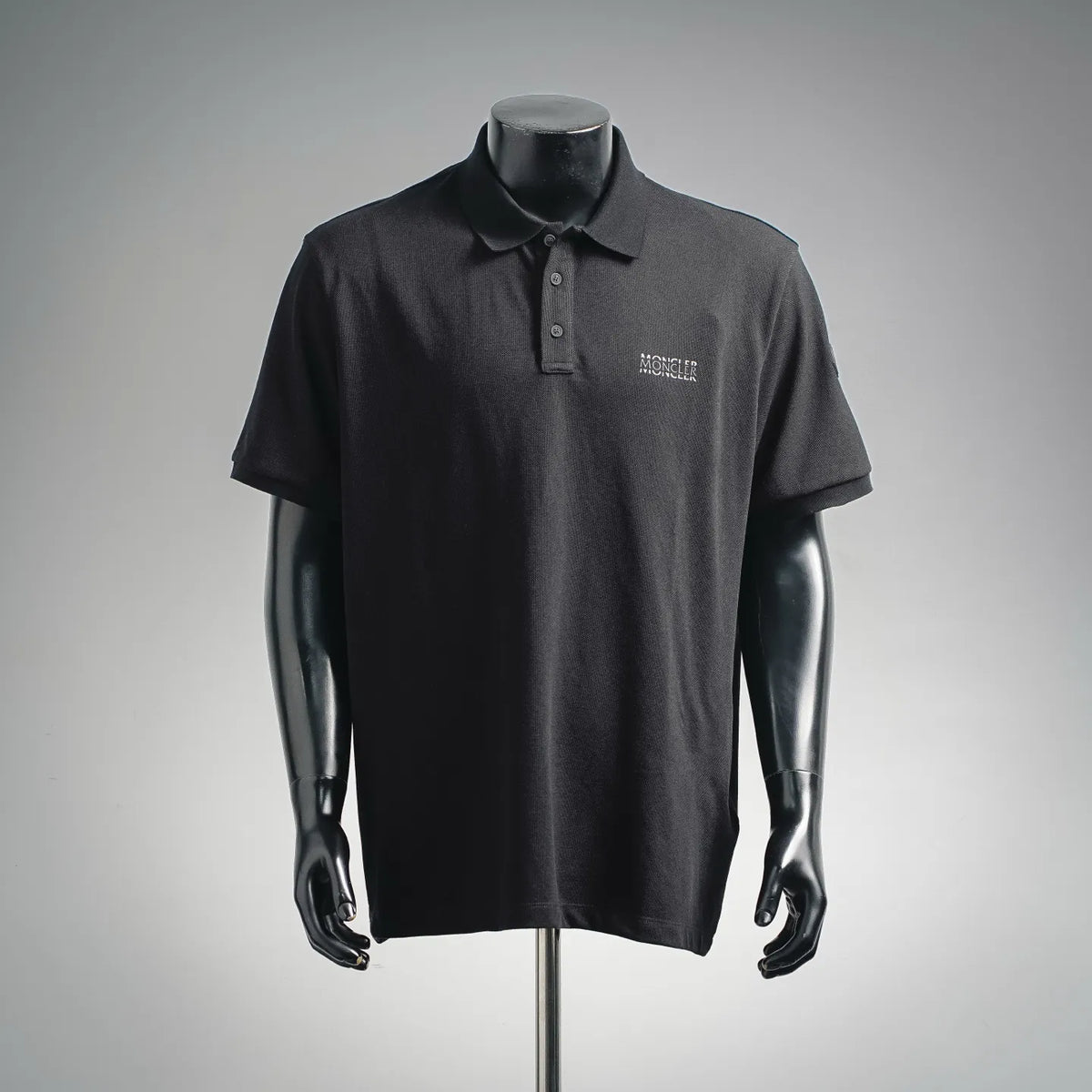 Dark short-sleeve polo shirt with Moncler logo on chest and buttoned collar