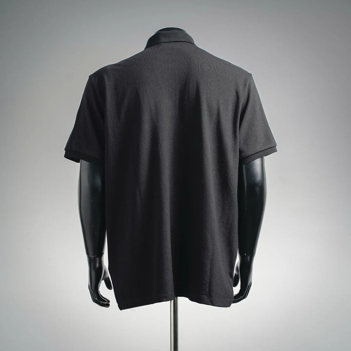 Dark short-sleeve polo shirt back view with clean shoulder and ribbed collar