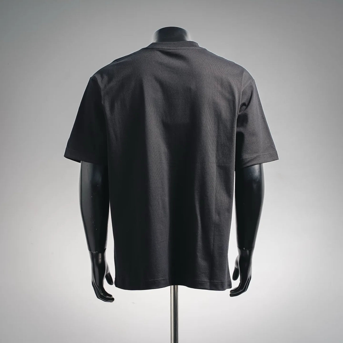 Dark short-sleeve T-shirt on a mannequin, back view