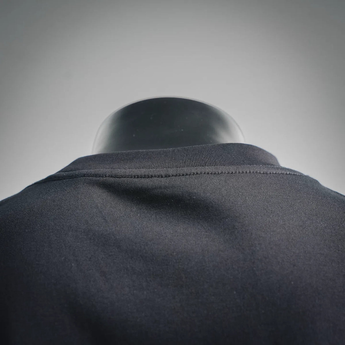 Dark short-sleeve T-shirt with ribbed crew neck, back close-up