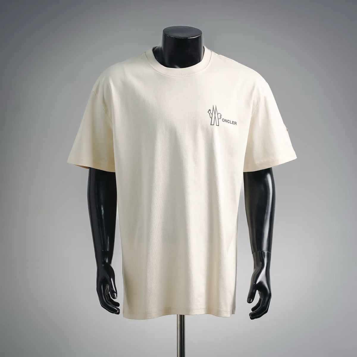 Cream short-sleeve T-shirt with small Moncler logo on the chest.