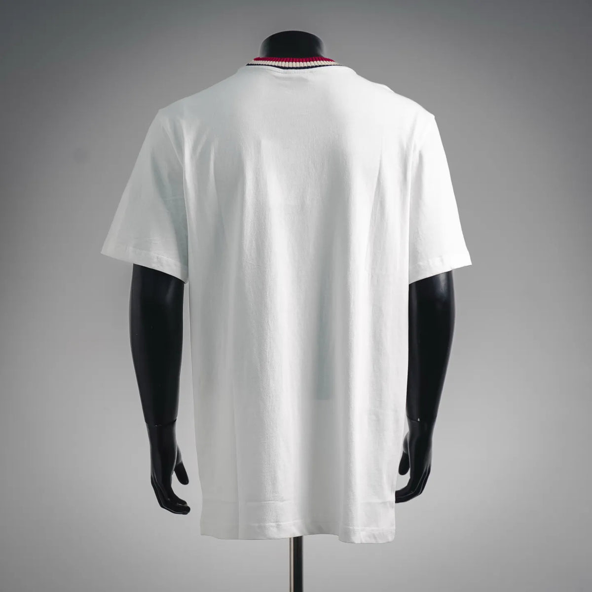 White Moncler short-sleeve T-shirt, back view with striped ribbed collar.