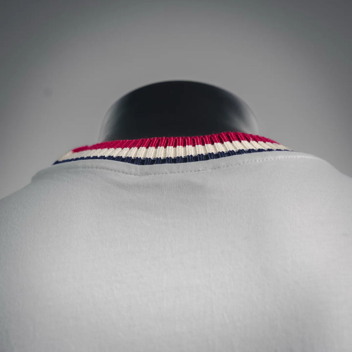 Striped ribbed collar on a white Moncler short-sleeve T-shirt.
