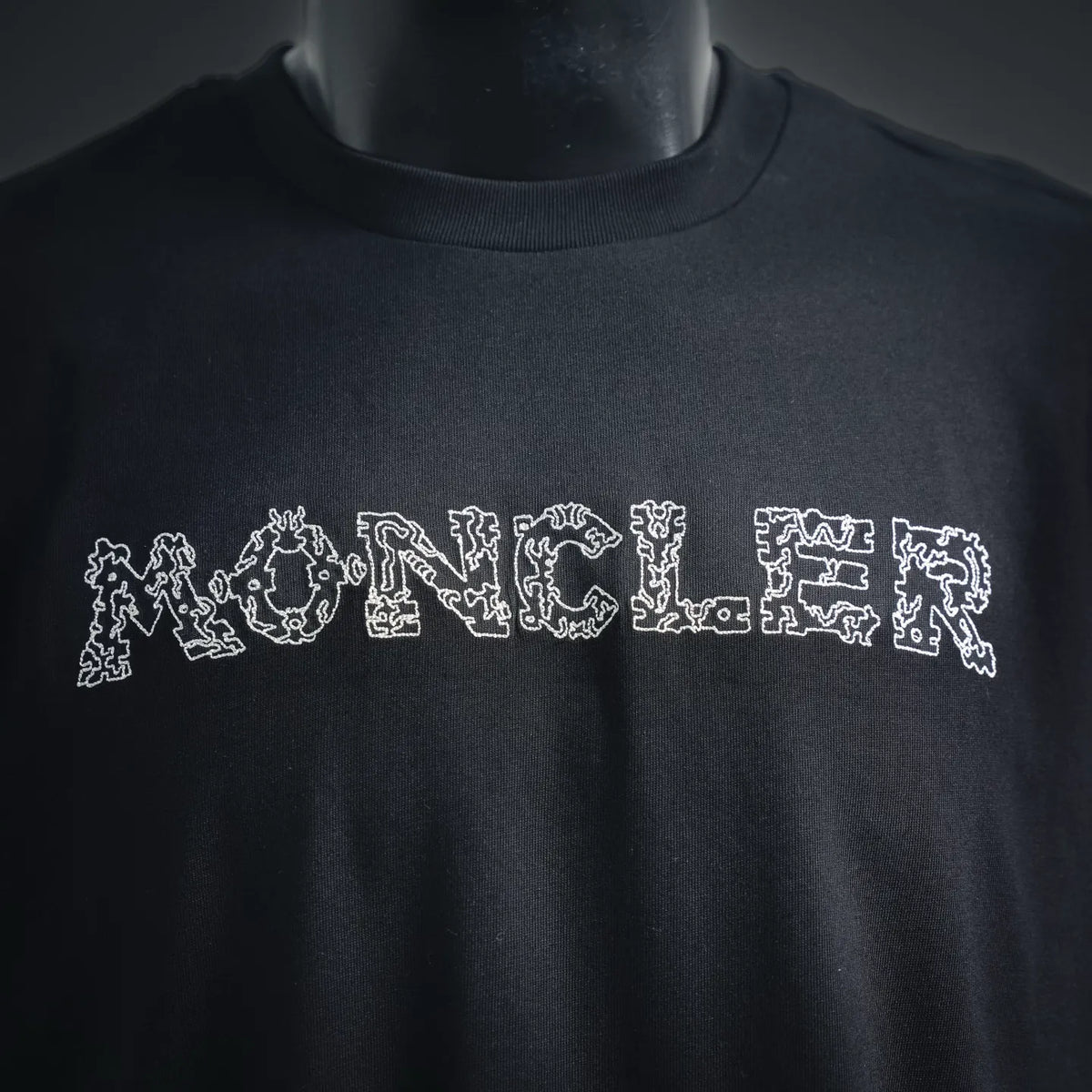 Moncler black T-shirt with large white MONCLER logo across chest