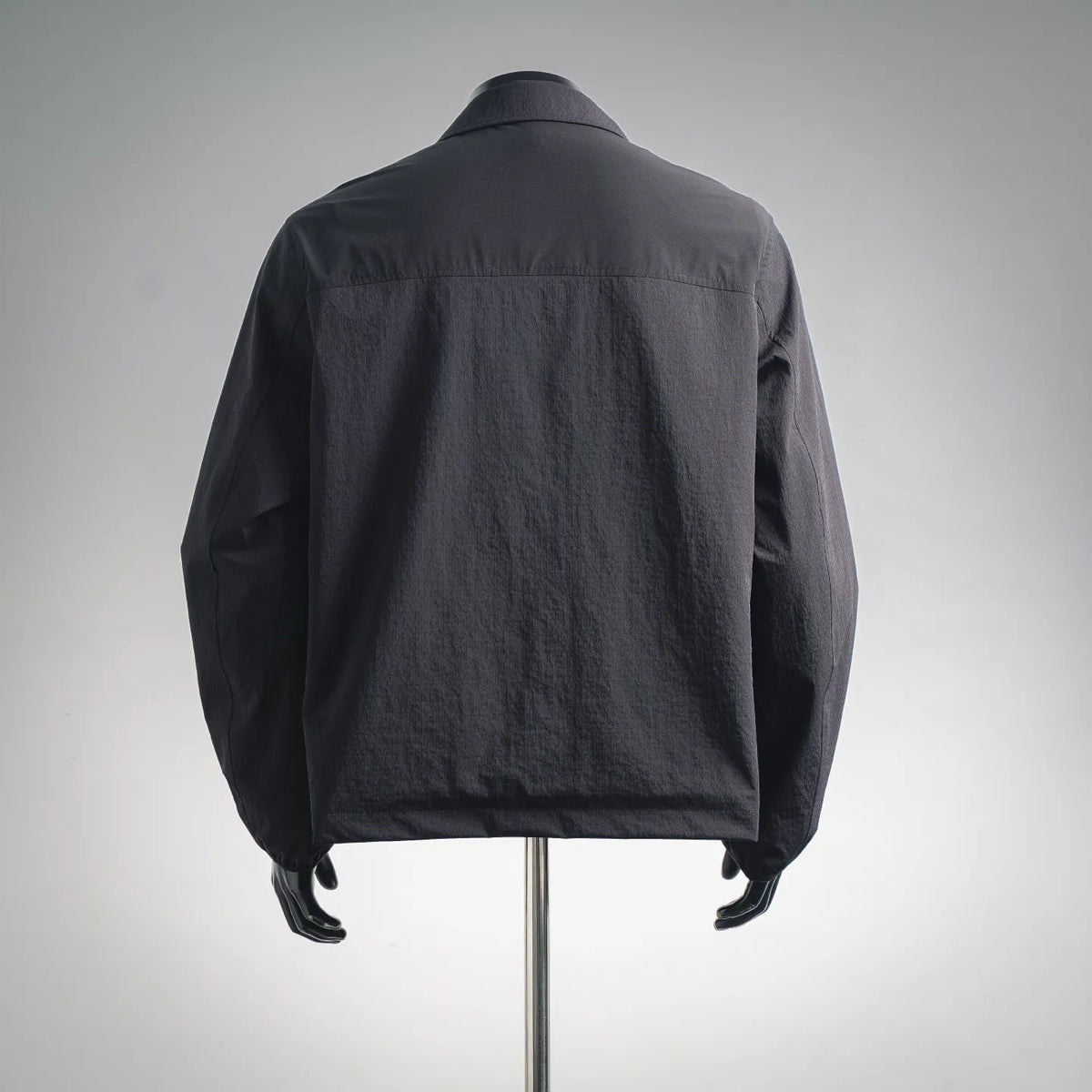 Men's Moncler coat back view in dark gray with full sleeves