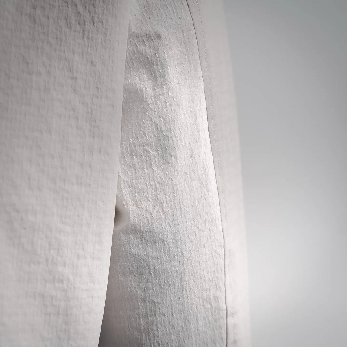 White Moncler coat sleeve seam and textured fabric close-up