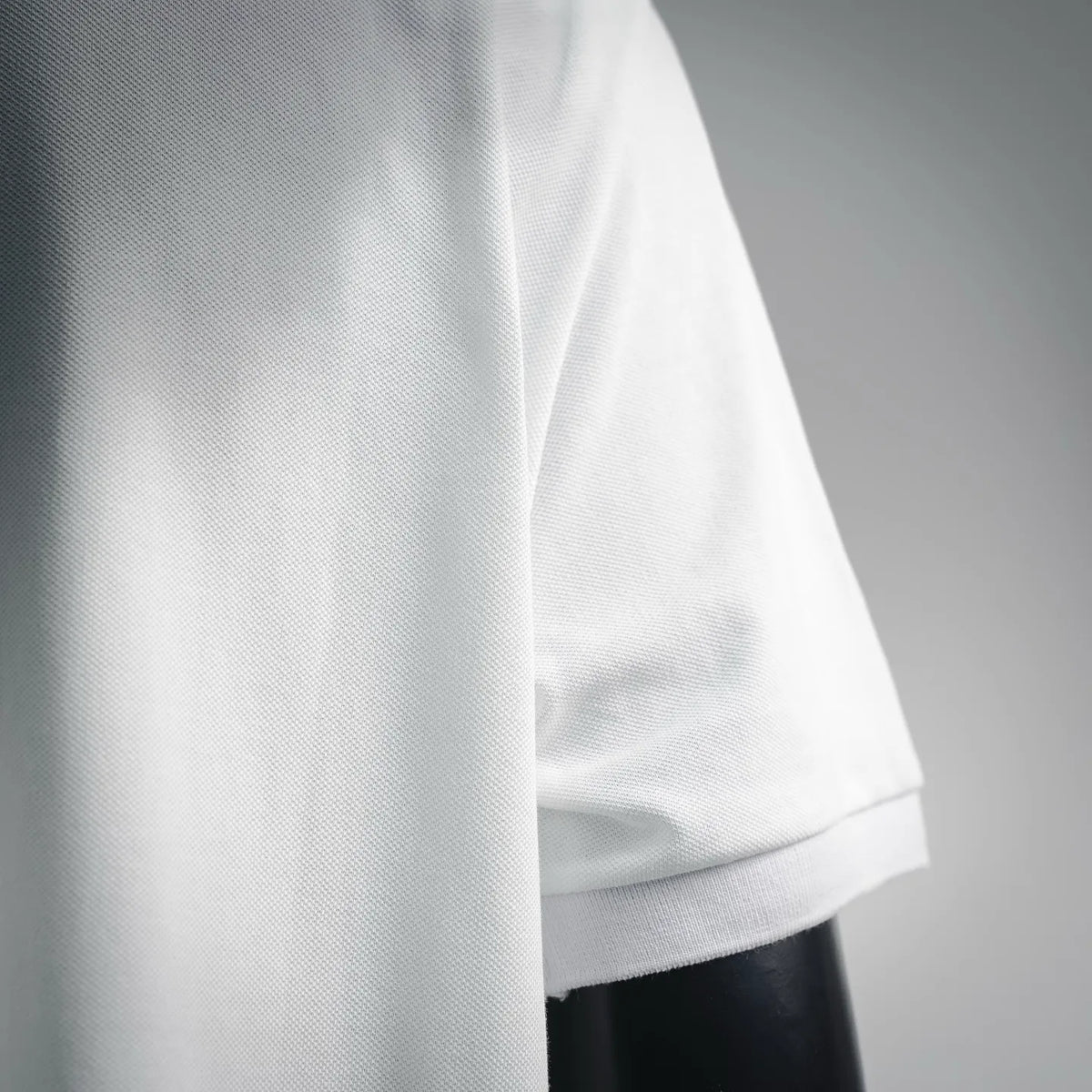 White polo shirt side and sleeve cuff seam detail
